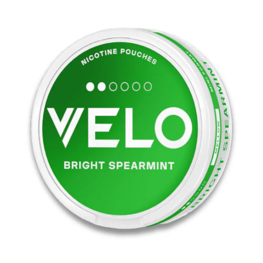 Green container of Velo nicotine pouches with spearmint flavor on a white background